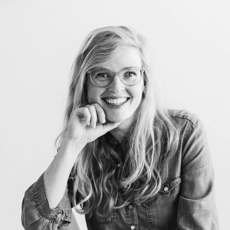 Dana Loberg, smiling, in glasses and a denim shirt
