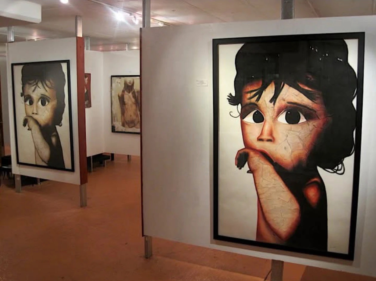 Large framed portrait paintings of wide-eyed children hanging in a gallery during Dana's solo exhibition in San Francisco